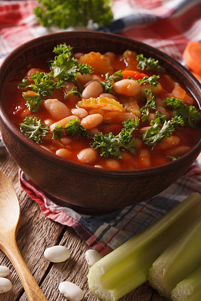 istock soup with beans, carrots and celery close-up. vertical 620735378