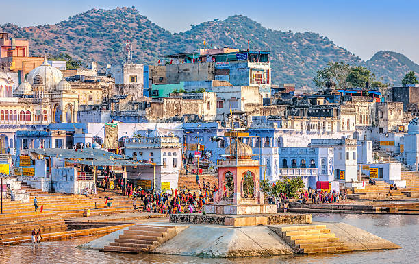 Sacred Pushkar Lake, Rajasthan, India Pushkar, India - November 20, 2012: Hindu pilgrims bathing in sacred Lake Pushkar (Sarovar) on ghats. Countless people in colourful attire gather to take a dip in the Holy Lake and pray to deities. ghat photos stock pictures, royalty-free photos & images
