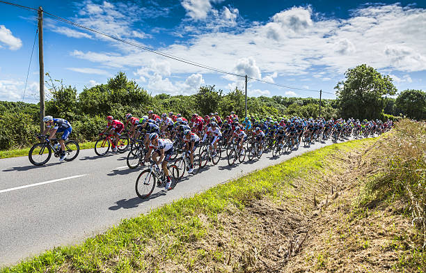 The Peloton - Tour de France 2016 Quineville, France - July 2, 2016: The peloton riding during the first stage of Tour de France in Quineville, France on July 2, 2016. tour de france stock pictures, royalty-free photos & images