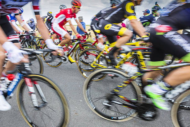 Ardevon, France - July 2, 2016: Abstract blurred image of the peloton taking the start of Tour de France at Km 0, close to Mont Saint Michel Monastery, in Ardevon,France on July 2,2016.