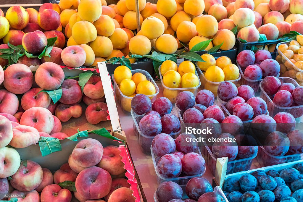 Peaches and plums for sale Different kinds of peaches and plums for sale at a market Palermo - Sicily Stock Photo