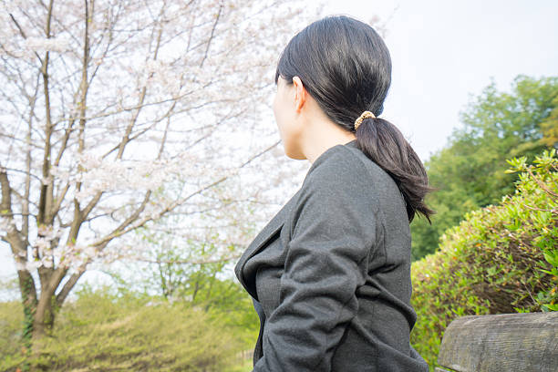 istock Young businesswoman looking at the cherry blossoms 620736330