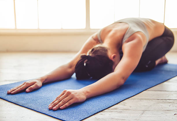 istock Young woman doing yoga 620737372