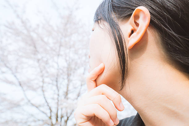 istock Young businesswoman looking at the cherry blossoms 620737406
