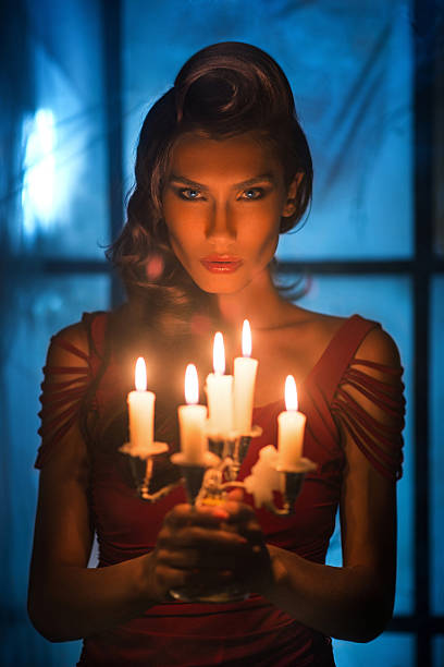 istock Woman looking on red candles in the fabulous night 620737528