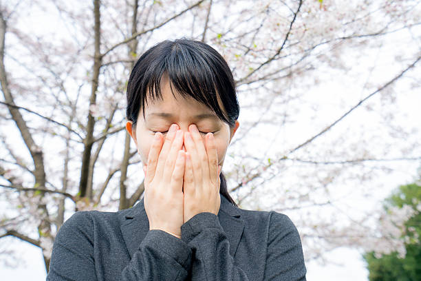 istock Young businesswoman crying under the cherry blossoms 620737874