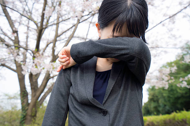 istock Young businesswoman crying under the cherry blossoms 620738138