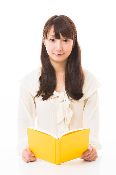 istock Japanese woman reading a book 620739334