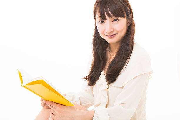 istock Japanese woman reading a book 620739458