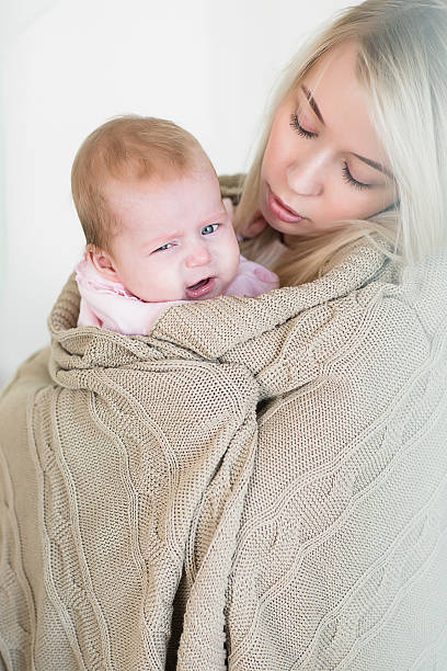 istock mother comforts, so as not to cry her infant daughter 620741596