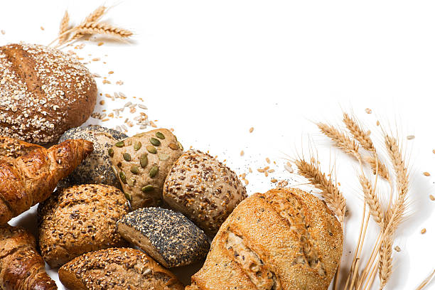 Variety of cereal bread Top view of assortment of different kind of cereal bakery: bread, croissants, buns isolated on white background. bun bread stock pictures, royalty-free photos & images
