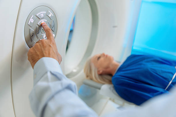 Radiologic technician and Patient being scanned and diagnosed on CT stock photo