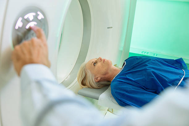 Radiologic technician and Patient being scanned and diagnosed on CT stock photo