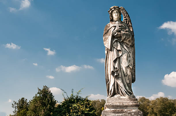 istock Sculpture of an angel with cross 620743430