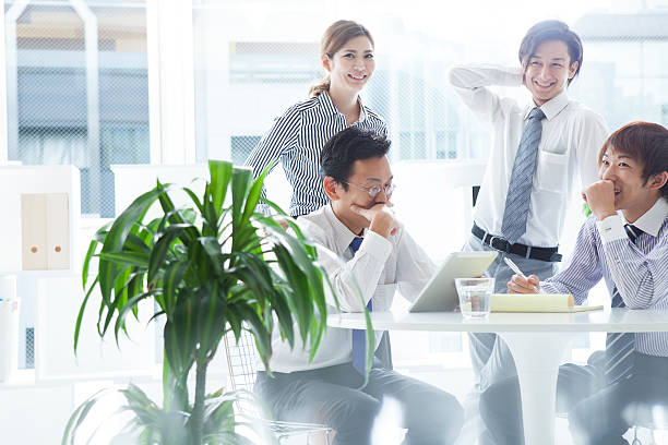 istock People who have meeting while looking at documentation of  tablet 620743720