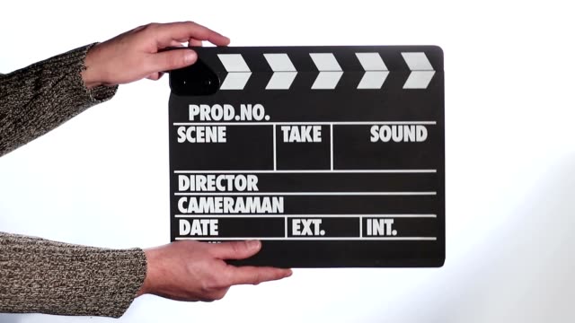 Close up of male hand holding movie clapperboard