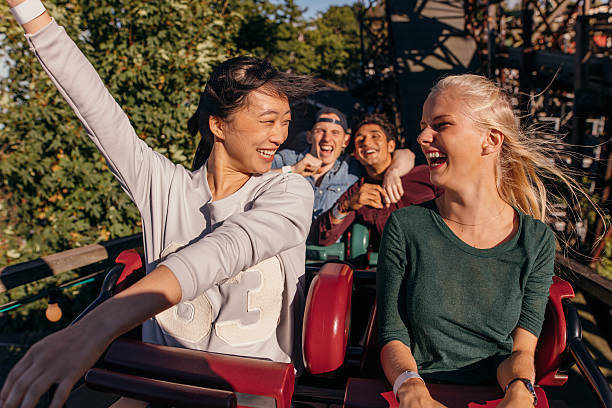 istock Friends enjoying and cheering on roller coaster 620954976