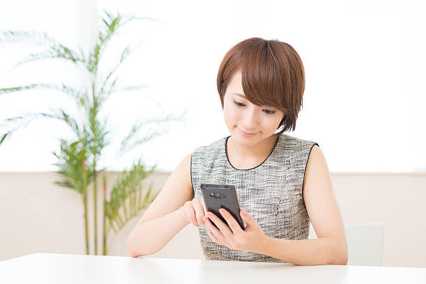 istock Japanese woman holding a smart phone 620955312