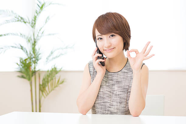istock Japanese woman talking on a smart phone 620956044