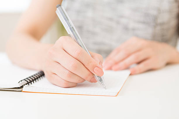 Japanese woman writing on a notebook stock photo