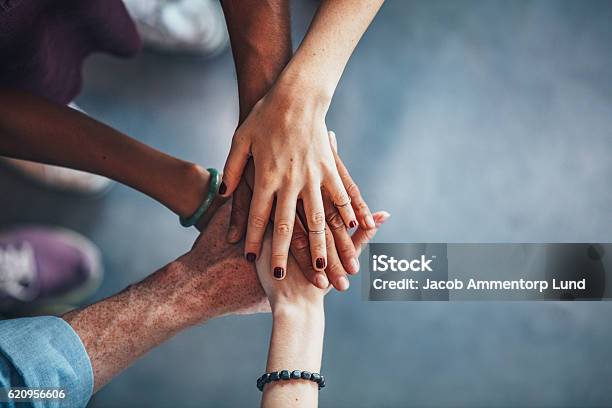 Sea Of Hands Showing Unity And Teamwork Stock Photo - Download Image Now - Stacked Hands, Stack, Unity