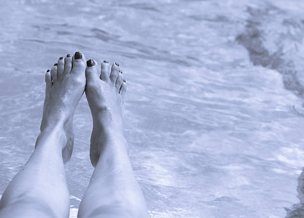 istock Woman legs on pool water 620957438