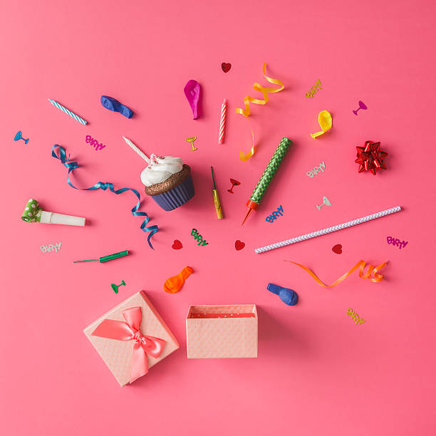 istock Gift box with colorful party items on pink background. 620958072