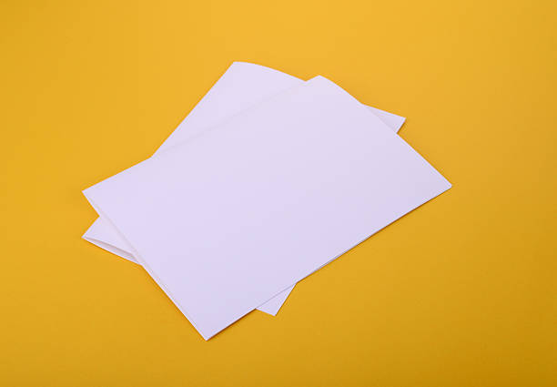 istock two white paper bifold brochure mockup on yellow background 620962958