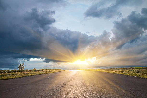 istock Country road at sunset 620964014