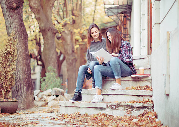 istock Female tutor teaching university student at college entrance 620966284