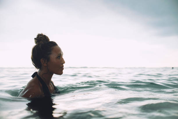 istock Young woman relaxes in tranquil sea 620966861