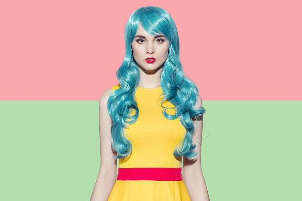 Pop art woman portrait. Blue curly wig and yellow dress Pop art woman portrait wearing blue curly wig and bright yellow dress.  Green-rose background. Space for text. crazy makeup stock pictures, royalty-free photos & images