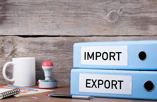 Import and Export. Two binders on desk in the office. Business background