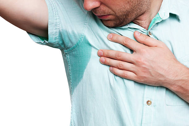 istock Young man in horror looking at the sweaty shirt 620968944