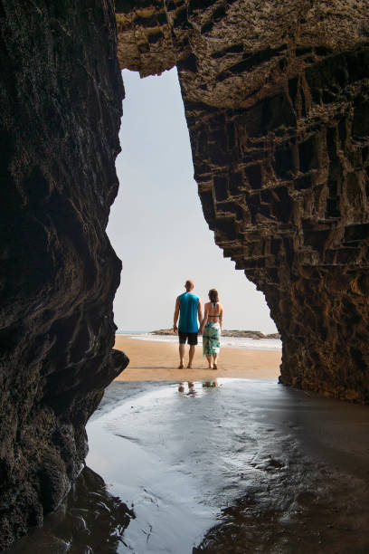 istock View through beach opening to contemplative couple 620969061