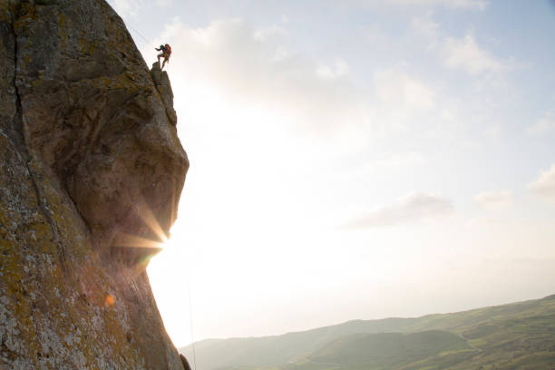 istock Climber prepares to descend from overhanging cliff 620969075