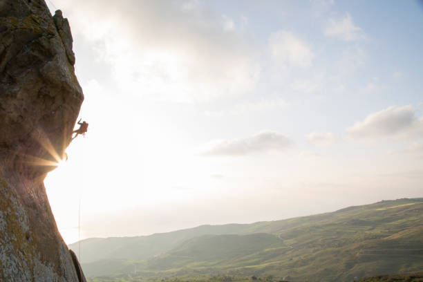 istock Climber prepares to descend from overhanging cliff 620969081