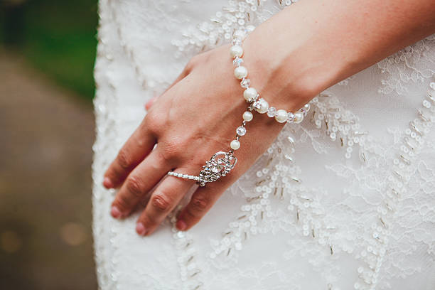 istock Bride's hand with a bracelet on her stomach 620969268