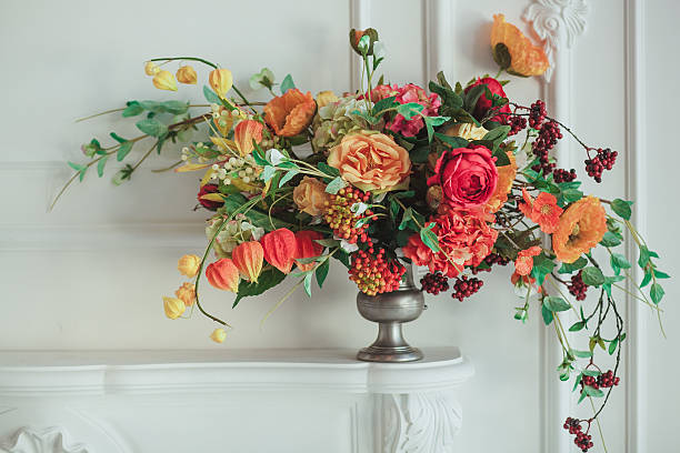 istock autumn bouquet on the fireplace. The cozy interior in white 620969348
