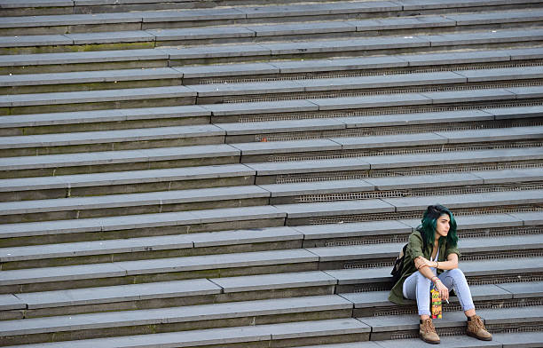 Woman in famous stairs on city square Sergels Torg, Stockholm Stockholm, Sweden - September 12, 2016: Woman alone in stairs. Popular resting and meeting place for shoppers, commuters or any pedestrians downtown Stockholm. The major stairs of Sergels Torg, famous landmark next to the subway entrance. stockholm town square sergels torg sweden stock pictures, royalty-free photos & images