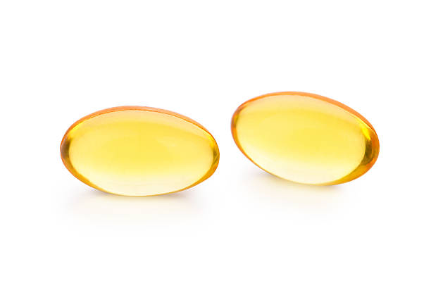 istock Fish oil pill isolated on white 620970568