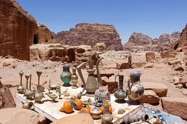 Landscape scenic view of campfire burning with cooking pots in barren desert environment
