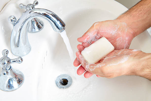 istock Male washing her hands in bathroom 620972106
