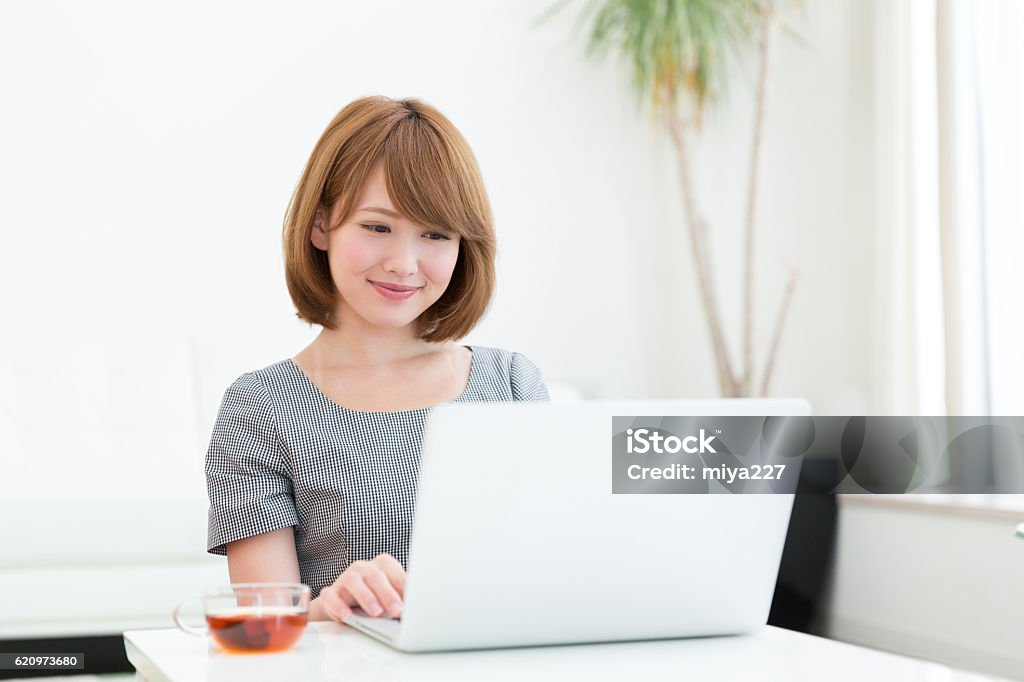 Japanese woman using a laptop Laptop Stock Photo