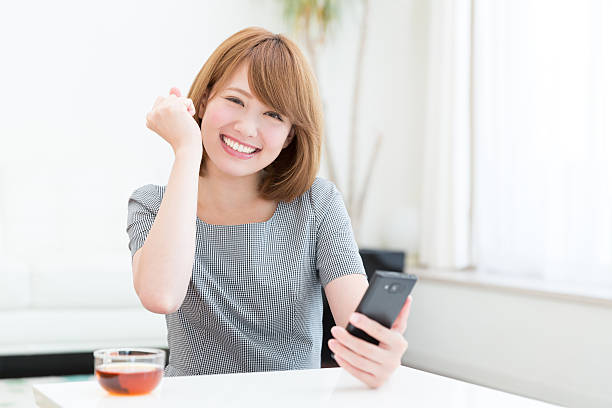 istock Japanese woman holding a smart phone 620975182