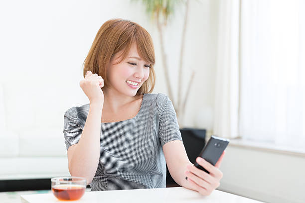 istock Japanese woman holding a smart phone 620975206