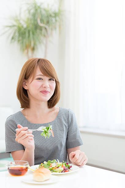 istock Japanese woman eating salad and bread 620975748