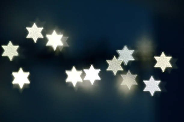 Beautiful bokeh lights in shape of the Star of David for Hanukkah celebration. Jewish Holiday background.
