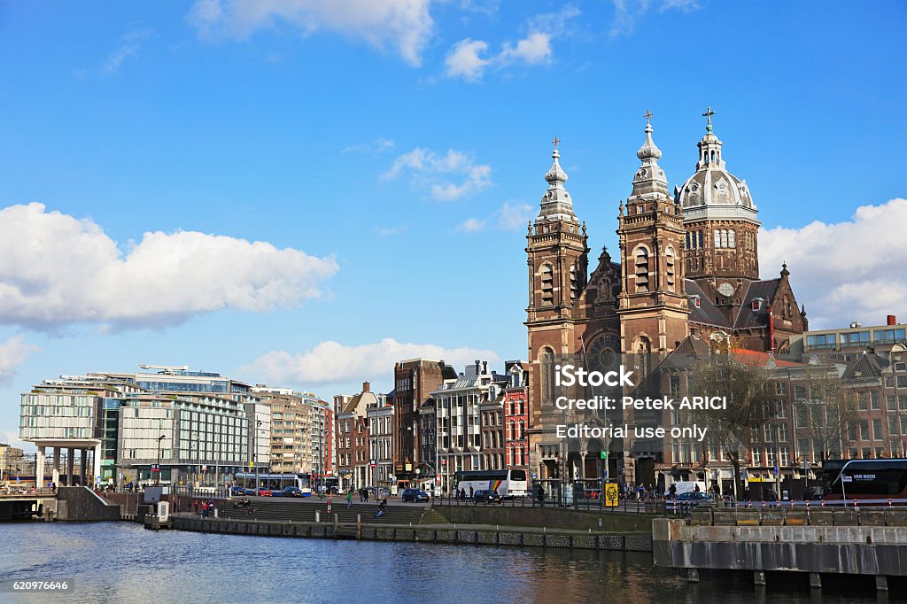 Church of Saint Nicholas in Amsterdam, Netherlands Amsterdam, Netherlands - May 3, 2016: A view towards the Church of Saint Nicholas in Amsterdam in a day, Buildings, people, bridges, cars and boats can be seen, Amsterdam, Netherlands. 2016 Stock Photo