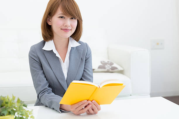 istock Japanese businesswoman reading a book 620976788